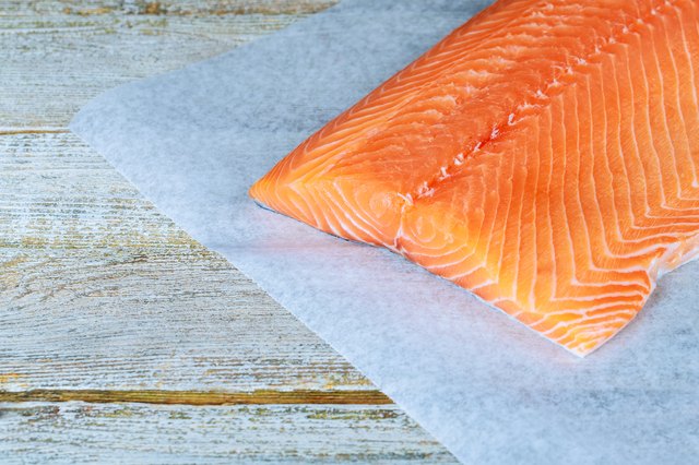 fresh raw salmon on wooden cutting board