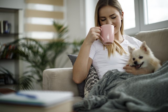 Woman relaxing at home with her dog