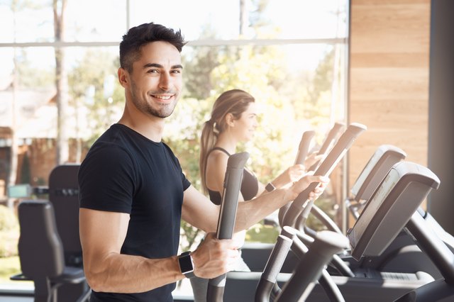 Young couple exercise together in gym healthy lifestyle