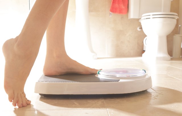 Stepping onto weighing scales