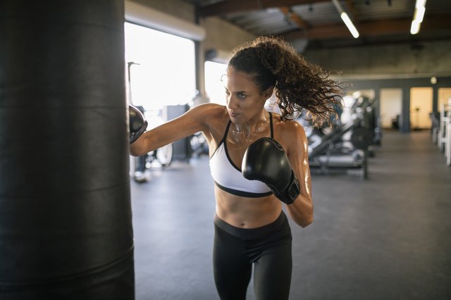 Female Boxer Hitting a Huge Punching Bag at a Boxing Studio Woman Boxer  Training Hard Stock Image  Image of gloves exercise 123742007
