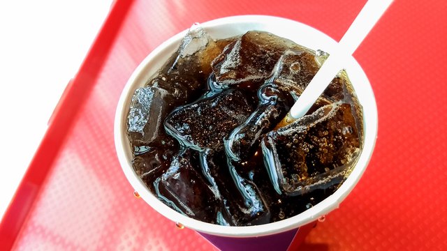 Closeup of coke with straw at Mcdonald’s