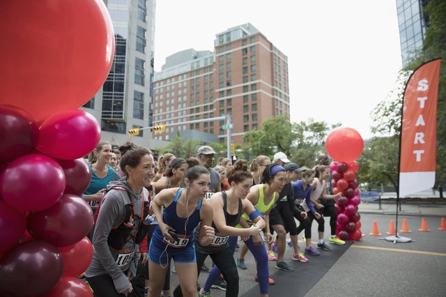 Marathon runners ready at starting line on urban street