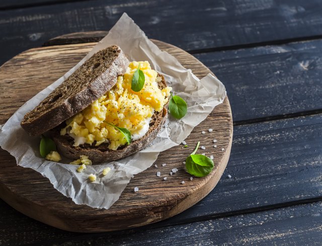 Scramble egg sandwich on rustic wooden background