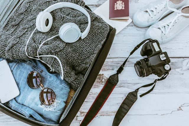 Open suitcase with casual female clothes ready to travel