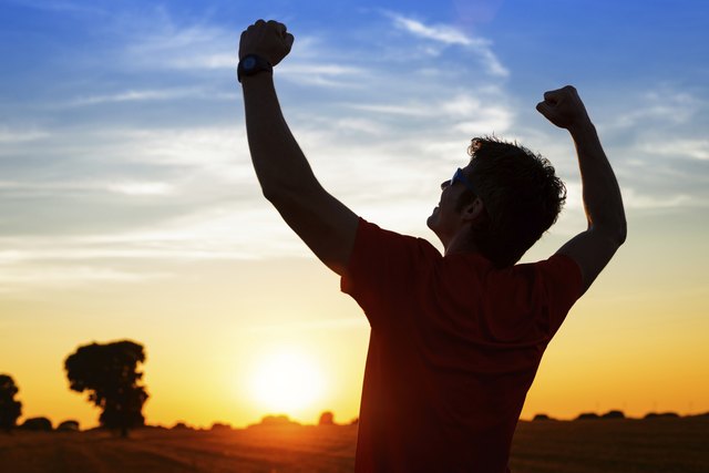Sportsman with arms up celebrating success