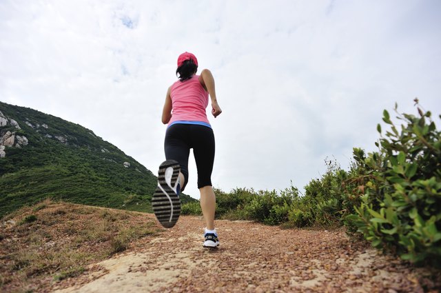 runner running on seaside mountain trail