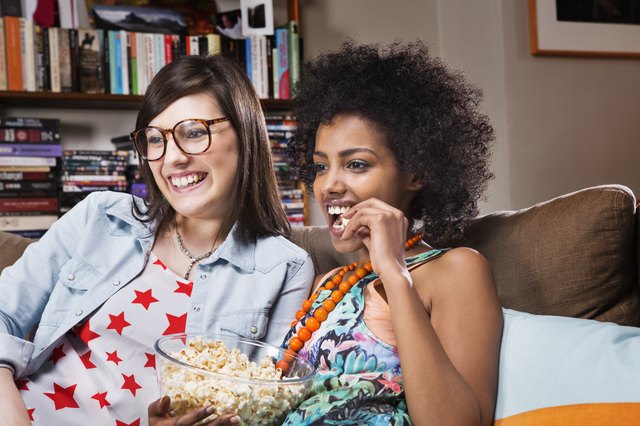 Women watching television in livingroom.