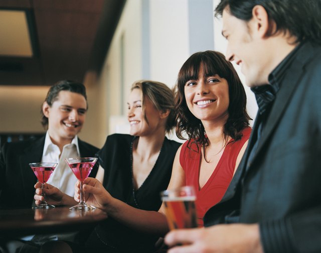 Friends Drinking Cocktails and Lager in a Bar