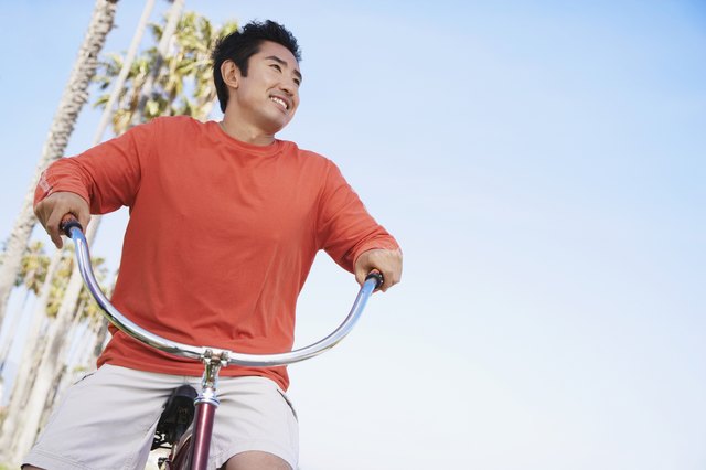 Asian man riding bicycle