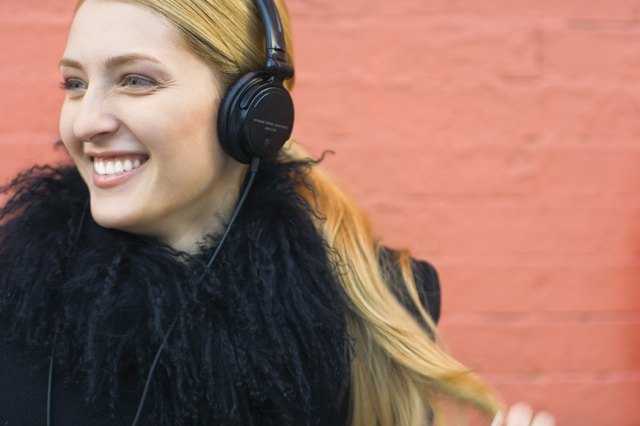 Woman wearing headphones and smiling