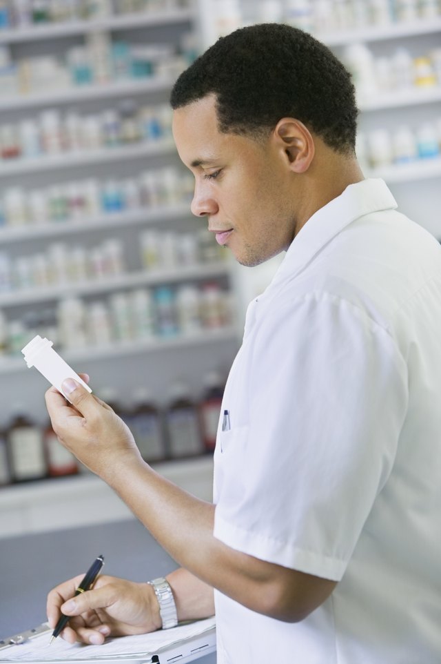 African American male pharmacist with prescription bottle