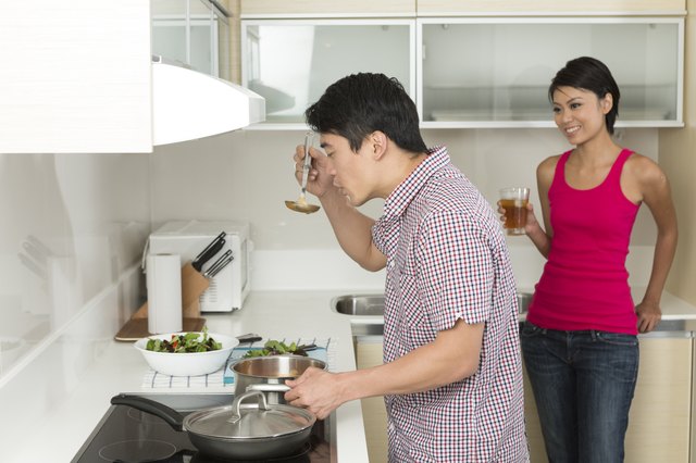Happy Asian couple together at home