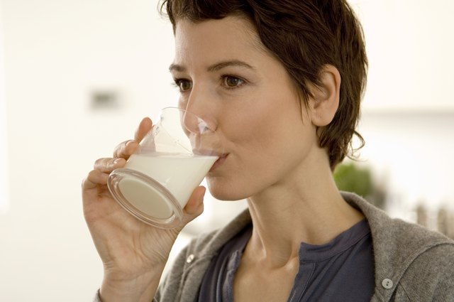 Close-up of a mid adult woman drinking a glass of milk