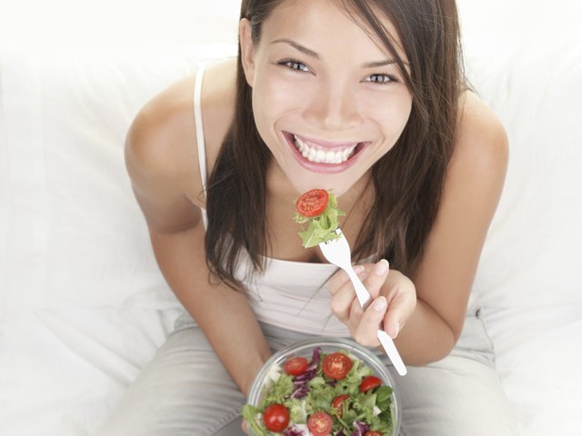 Girl eating healthy salad portrait