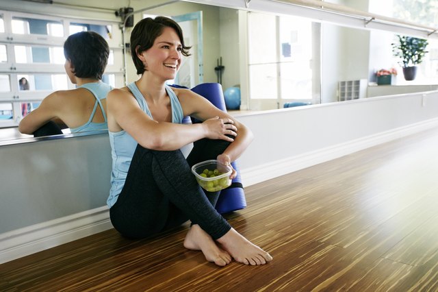 Caucasian woman smiling in yoga studio