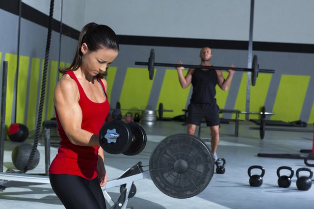 girl dumbbell and man weight lifting bar workout