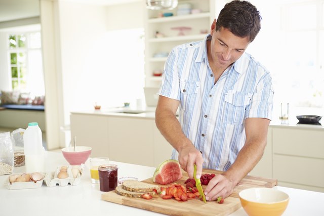 Man Preparing Healthy Breakfast In Kitchen