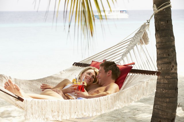 Romantic Couple Relaxing In Beach Hammock