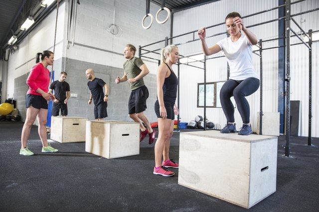 Crossfit group trains box jumps