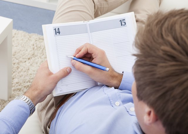 Young man writing in diary