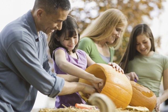 Family carving pumpkins