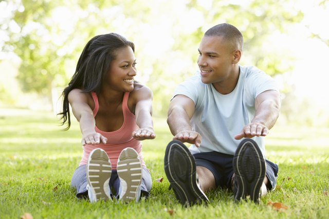Young African American Couple Exercising In Park