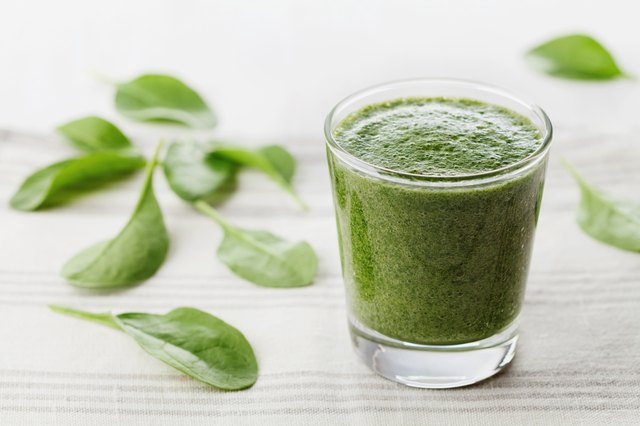 Green spinach smoothie in glass, detox and diet food
