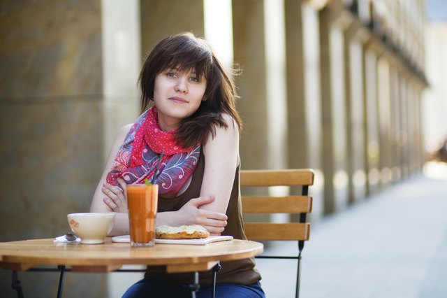 Young girl having breakfast in a cafe