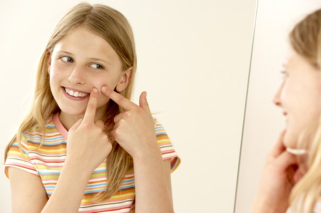 Girl popping pimple