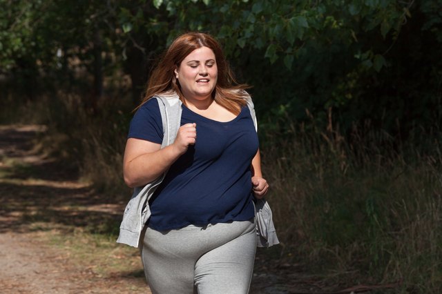 overweight woman running outdoors