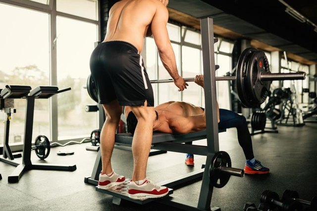 Muscular bodybuilder bench press workout