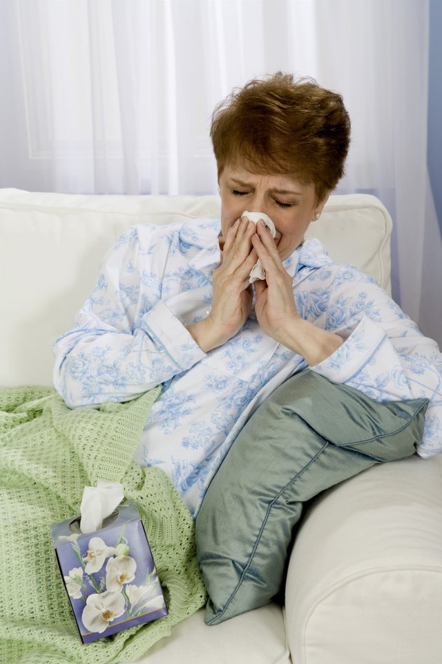 Woman blowing nose