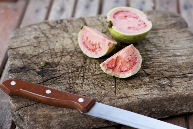 Guava on old wooden chopping board
