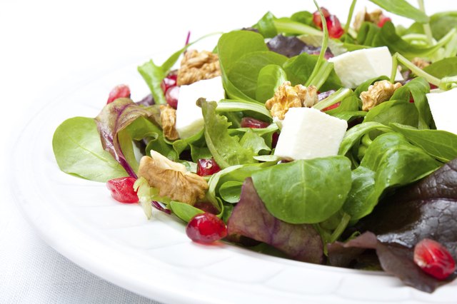 Mix salad with pomegranate, cheese and nuts