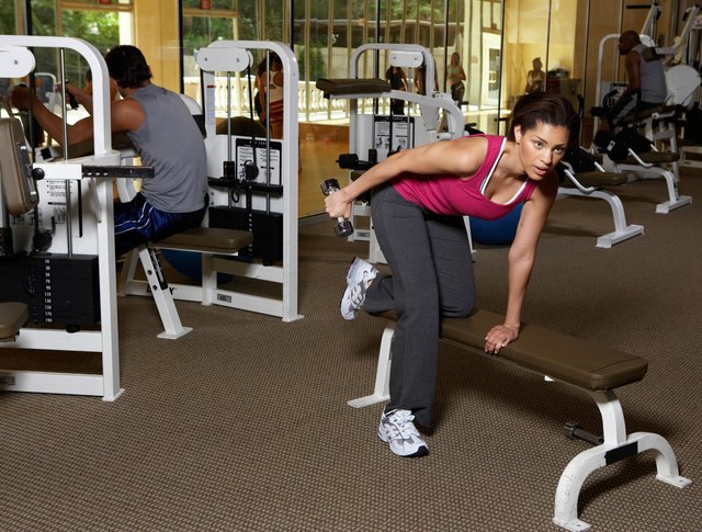 Man and woman doing exercise in gym