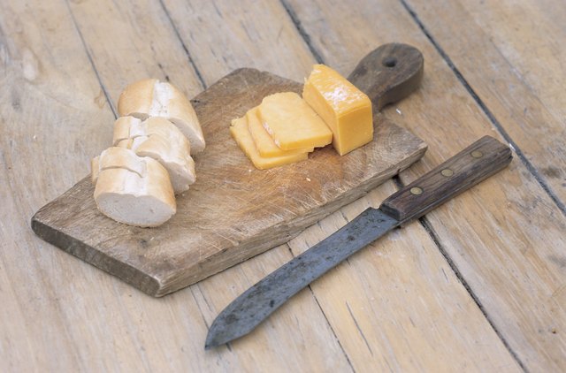 Sliced bread and cheese on cutting board