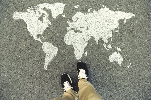 World map on an asphalt road
