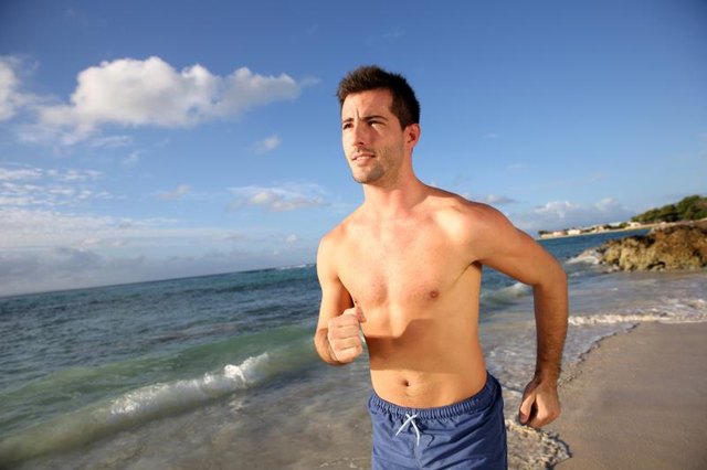 Young man running on the beach