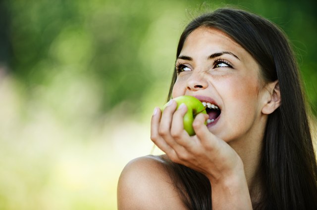 portrait young charming woman biting apple
