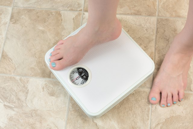 woman standing on a weight scale