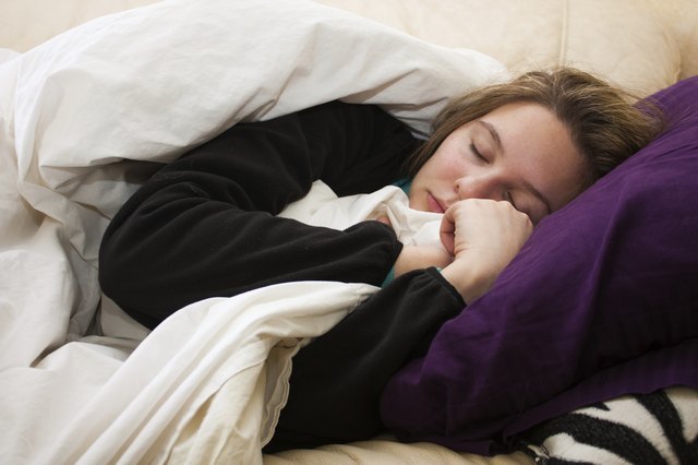 Sick young woman sleeps on couch