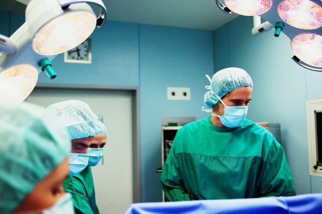 Operating theatre team tending to patient