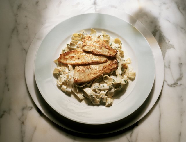 Tagliatelle with cream sauce and fried fish fillet