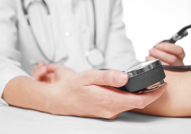 Doctor measures blood pressure