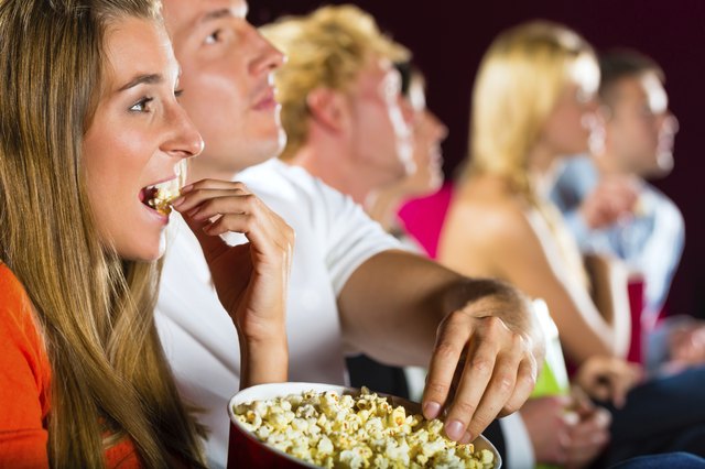 Young people watching movie at cinema