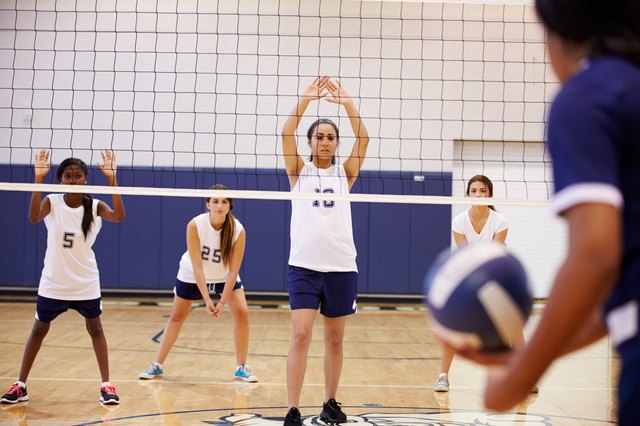 High School Volleyball Match In Gymnasium