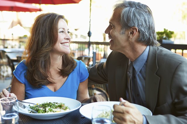 Mature Couple Enjoying Meal At Outdoor Restaurant