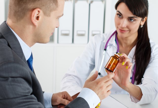 Beautiful female medicine doctor giving pills to male patient