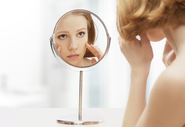 young beautiful healthy woman and reflection in the mirror